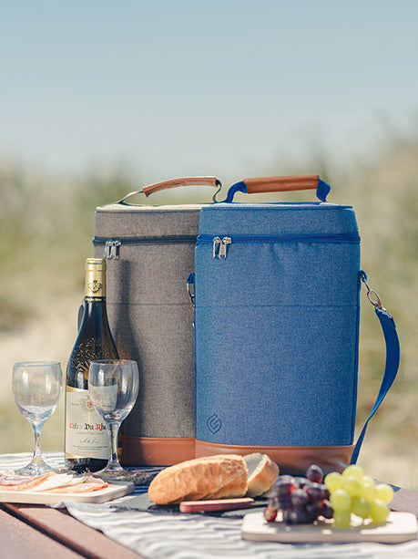 two wine coolers on picnic bench at beach