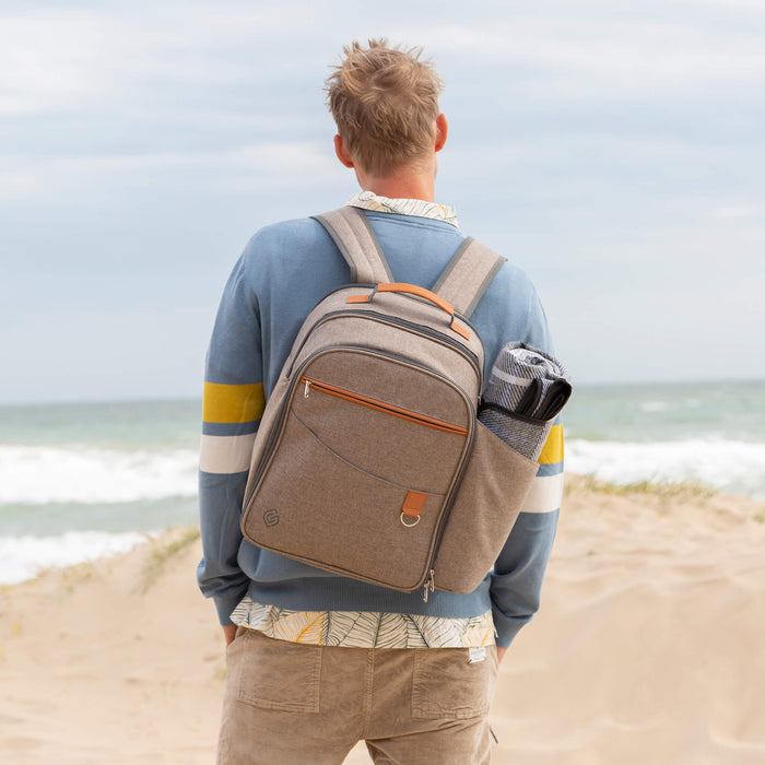 Man wearing picnic backpack at beach - Greenfield Collection